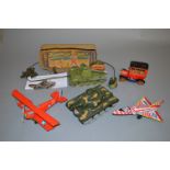A mixed group of unboxed tinplate and plastic toys including a car, two aeroplanes,