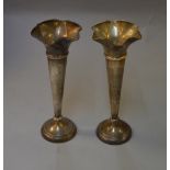 A pair of silver vases H/M London 1904, bases filled, approx 250mm high,