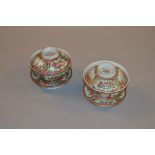 A pair of Famille Rose cups and covers with stands. Diameter of cup 11cm.