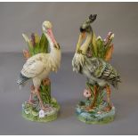A pair of late 19th century/ early 20th century Majolica floor vases in the form of herons (s/d).
