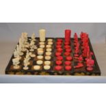 A Georgian stained ivory chess and backgammon set, mostly complete with some damage.