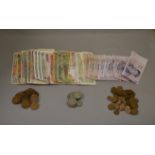 A mixed lot of vintage British and World currency, coins and notes.