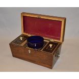A regency sarcophagus mahogany tea caddy with two lidded compartments and Bristol blue central