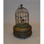 Clockwork singing bird in cage.