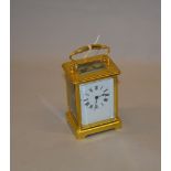 A French brass cased carriage clock with Roman numeral dial.