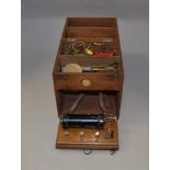 A W. Gibbons electric shock therapy device contained in a wooden carry case.