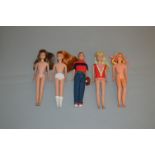 Five Mattel Barbie dolls: three Skipper dolls, blonde,