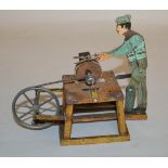 An unboxed vintage clockwork tinplate Scissor Sharpener model, made in Germany, probably by Arnold.