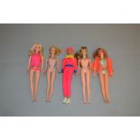 Five Mattel Barbie dolls: blonde Ponytail Barbie; Walk Lively Barbie; Malibu Barbie;