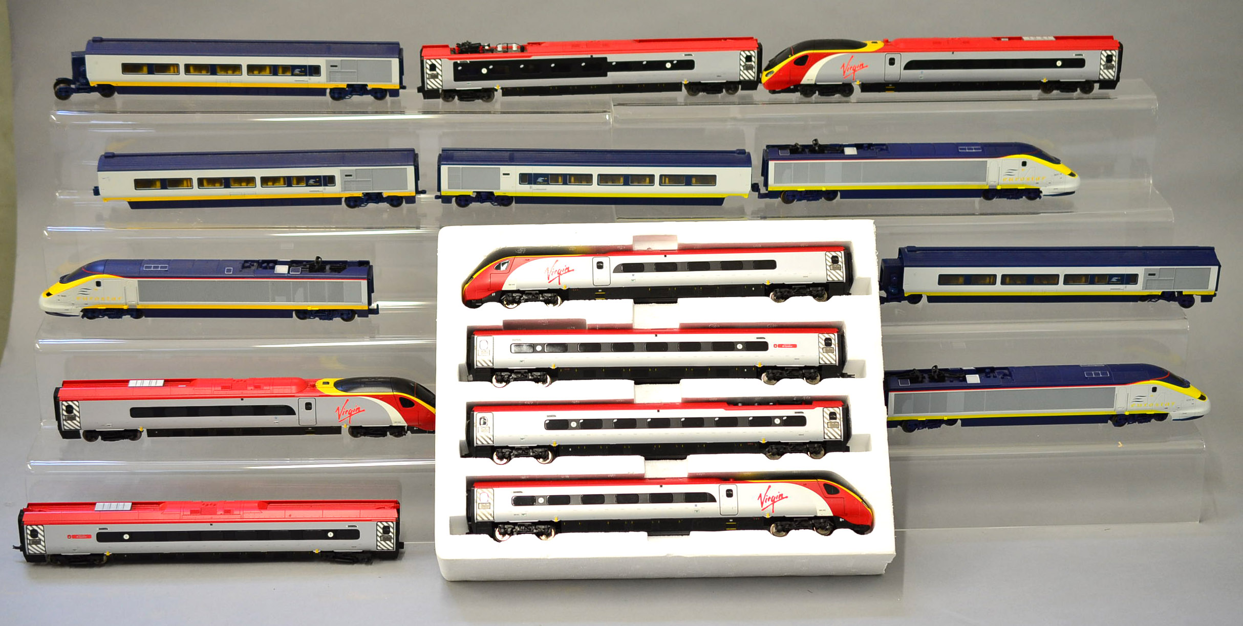 OO gauge. Four unboxed train packs: two Virgin Pendolino sets; two Eurostar sets.