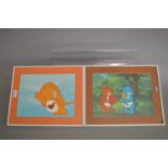 Two framed hand painted cells from The Care Bears film. One with smashed glass.