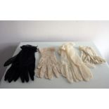 A collection of 4 pairs of vintage short gloves including one ivory sheer nylon, black sheer nylon,