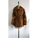 Vintage 1970s belted rabbit fur coat size 10. Lining worn but repairable. Great fluted sleeves.