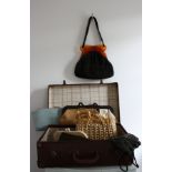 A vintage suitcase with 8 vintage bags that include a 1930s suede handbag with a tortoiseshell