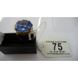 A 9ct gold ring set with a large blue stone, total weight 9.15g