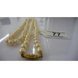 A string of cultured pearls with a 9ct gold clasp, total length 76 cm