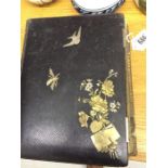 A Victorian photograph album decorated with brass insects, birds and flowers