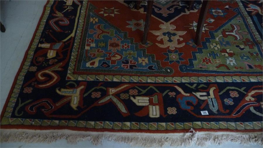 A large red and blue ground rug with Turkish influence