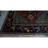 A large red and blue ground rug with Turkish influence