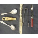 A pair of brass nutcrackers in the form of ladies legs along with 5 items of silver plated cutlery