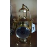 A brass clock with built in barometer and compass etc.