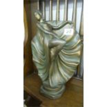 A plaster figure of a scantily clad Art Deco lady