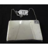 A hallmarked silver purse on chain with leather interior