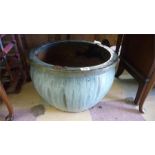 A large blue gazed garden pot