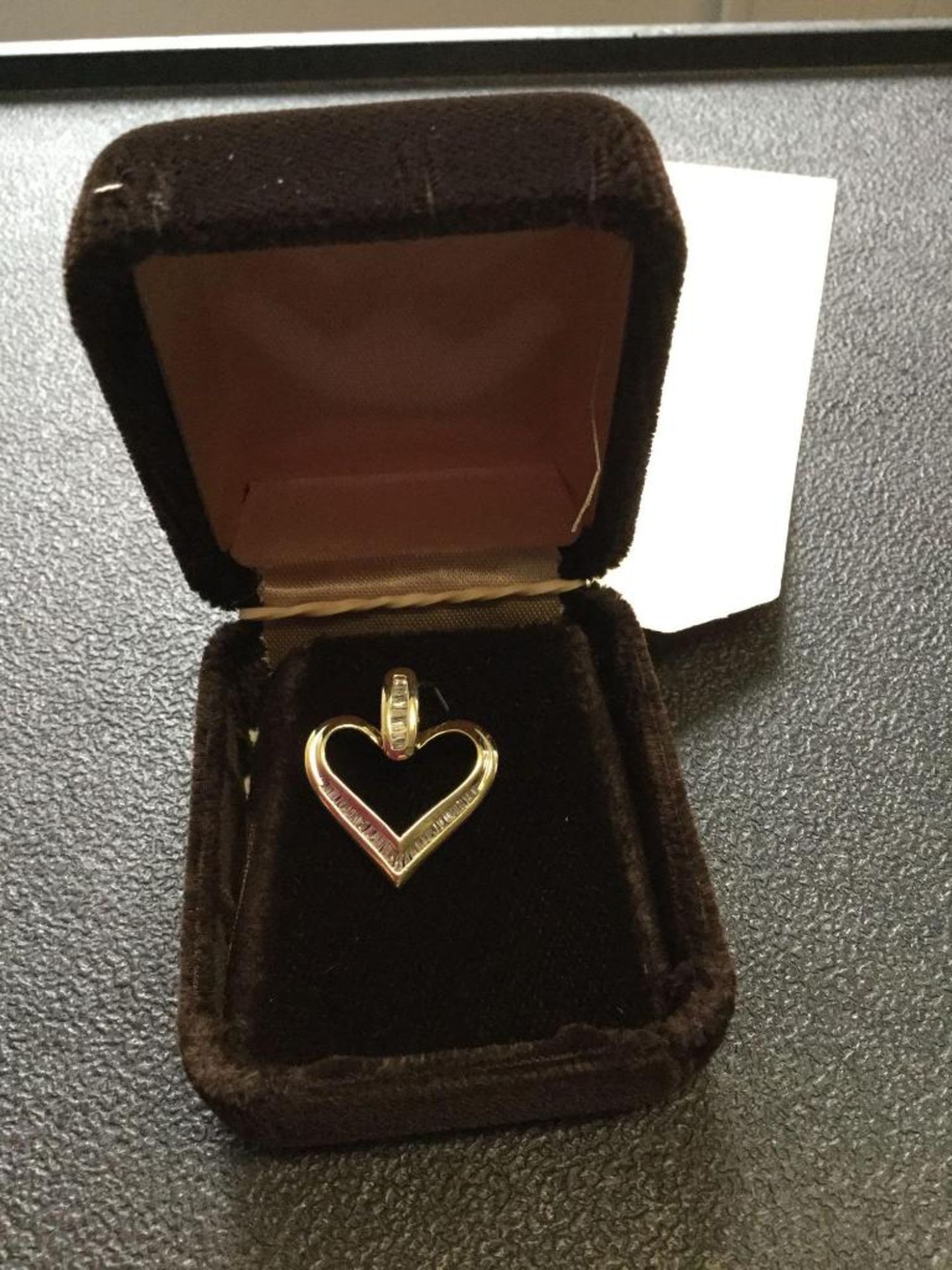 Heart Shaped Pendant- 10 kt with Baguette Diamond approximate 0.50 ct - Value 2085.00 (17-ED 6541)