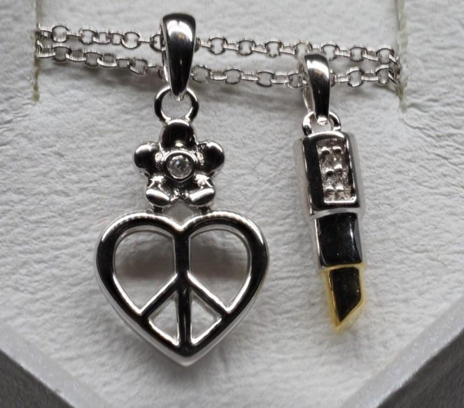 A Pair Of Sterling Silver Rhodium plate Diamond Lipstick and Heart Peace Sign Necklaces Retail $240