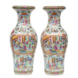 A pair of Chinese baluster shaped vases, famille rose decorated with scenes from court life and