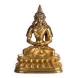 A Chinese gilt bronze seated Buddha, traces of polychromy, 18thC