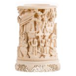 A Chinese richly carved ivory brush pot, overall decorated with an animated scene, late 19thC