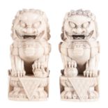 A pair of Chinese ivory Fu lions temple guards on a soccle, marked, 1st half 20thC, H 10 cm -