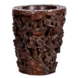 A richly carved Chinese bamboo brush pot, overall alto relievo decorated with an animated scene,