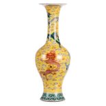 A Chinese yellow ground baluster shaped vase, polychrome decorated with dragons and the flaming