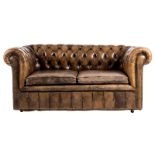 A Chesterfield two-seater sofa with leather upholstery, H 75 - W 175 cm