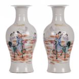 A pair of Chinese famille rose baluster shaped vases, decorated with an animated scene, marked