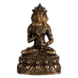 A Sino-Tibetan bronze seated Buddha with traces of gilt and polychromy, H 15 cm