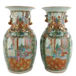 A pair of Chinese Canton vases, famille rose, decorated with a court scene, H 34 cm