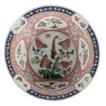 A Chinese famille rose decorated bowl, the roundels with birds and flower branches, 19thC,