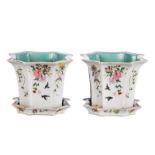 A pair of Chinese octagonal famille rose jardinieres with matching plates, overall decorated with