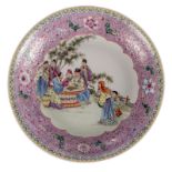 A Chinese famille rose decorated plate with an animated scene and floral motifs, marked, Diameter 37