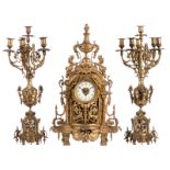 A bronze / brass renaissance revival garniture (center clock and two candelabra), H 67 - 68,5 cm