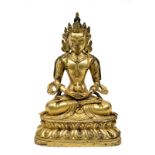 A Sino-Tibetan gilded bronze seated Buddha, traces of polychromy, H 21 cm