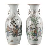 A pair of Chinese famille rose and polychrome decorated vases, one with court ladies with children