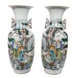 A pair of Chinese polychrome vases, decorated with sages and a landscape with figures, signed, H
