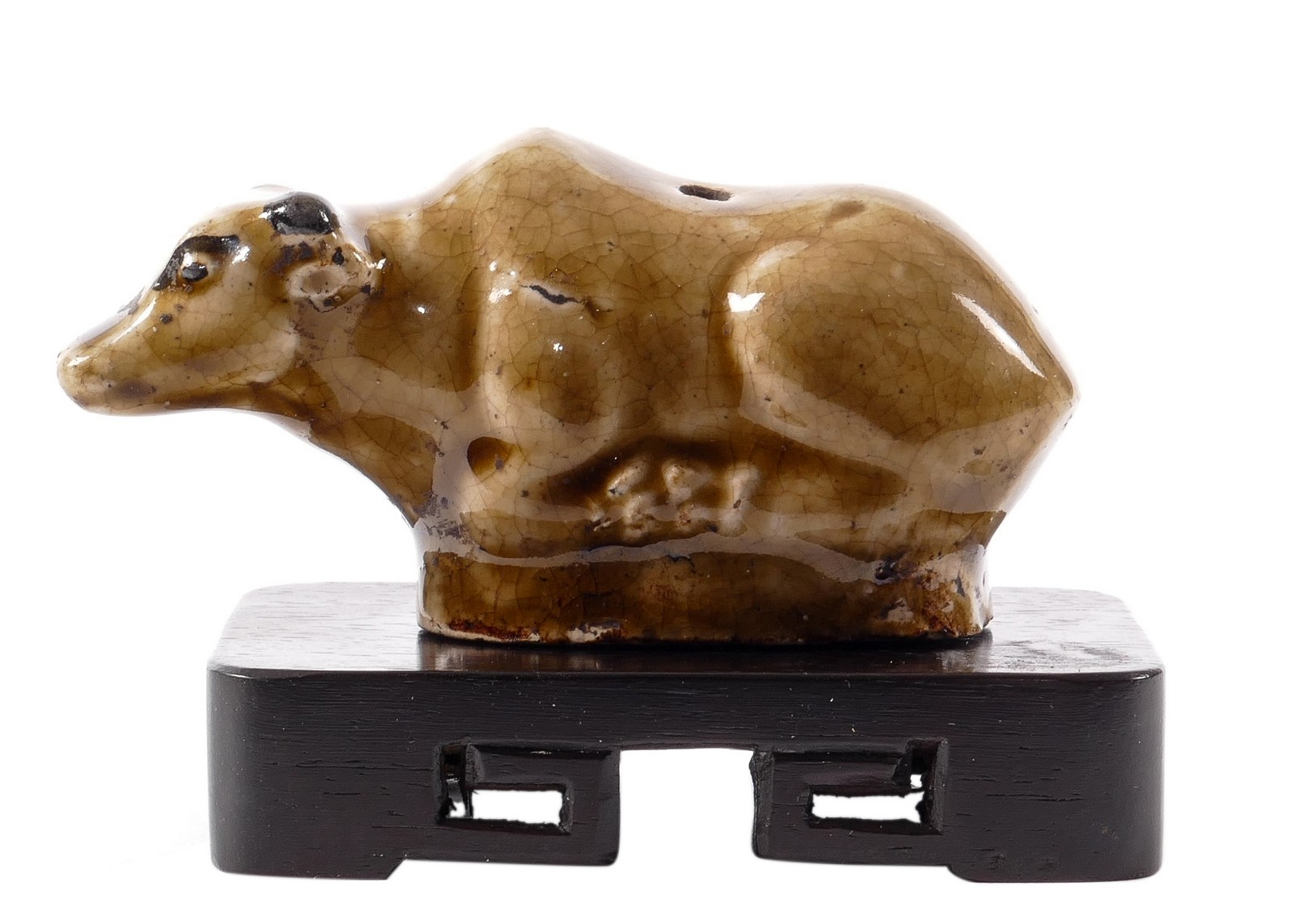 A Chinese stoneware glazed buffalo on a wooden base, H 5 - W 10 cm (base included)