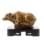 A Chinese stoneware glazed buffalo on a wooden base, H 5 - W 10 cm (base included)