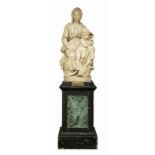 A patinated gypse sculpture, depicting Michelangelo's Madonna with Child, on a matching wooden